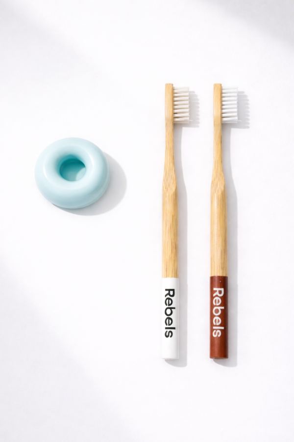 two toothbrushes and one ceramic holder